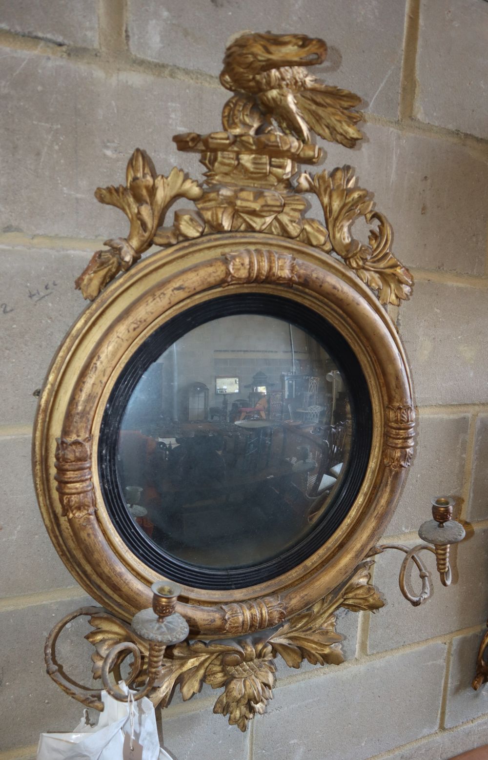 A Regency giltwood and gesso convex girandole, W.58cm, H.98cm (in need of repair but pieces are present)